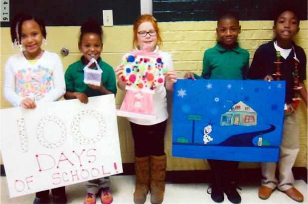 Winners were, pictured (l-r ): First place, Erkijah Davis with her shirt of 100 buttons; second place, Zion Collins with a house made with 100 Q-tips; third place, Isabella Lax with a bank with 100 gum balls. Honorable mention, Brandon Bufford with drawing with 100 snowflake;  honorable mention, Akevious Haddix with a necklace made with 100 gummy savers.