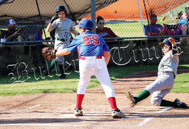John Baker slides into home for the first run of the game on July 22 against Jackson County National. 