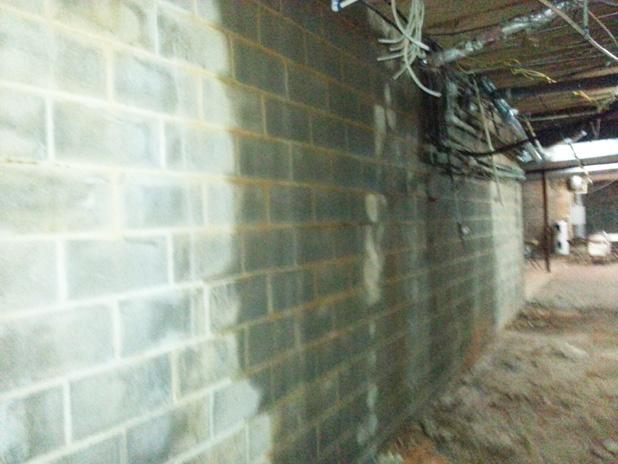 The Grand Valley Lakes Board has approved a contract with Olshan to remove a bow in the concrete block wall beneath the Property Owners Lodge.