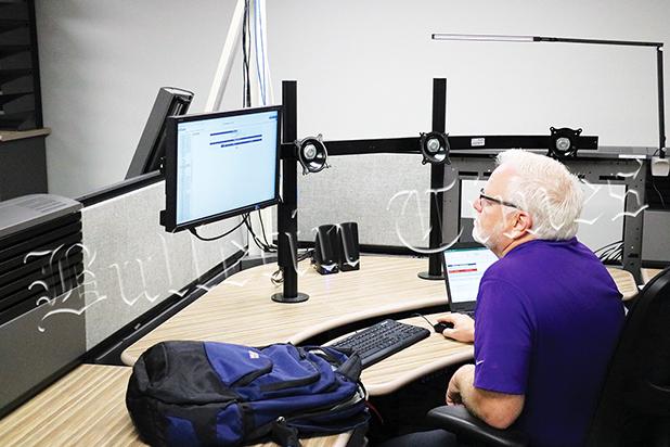 Jeff Rogers of Intrado, a data company that is setting up aspects of the new 911 system at the location on Jackson Street in Bolivar that will house 911 beginning August 11. Technicians from AT&T were also working on the system.