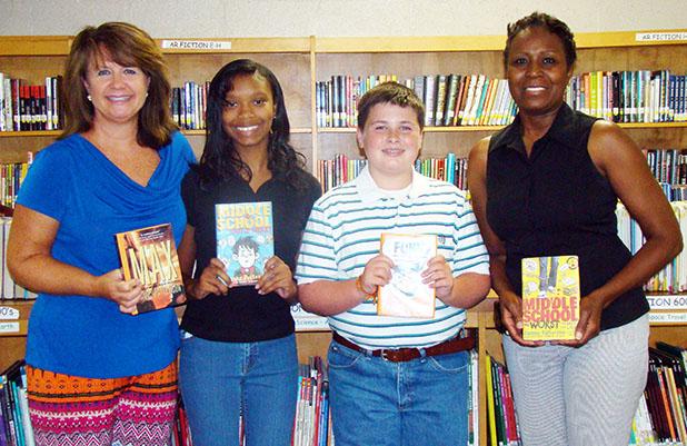 Bolivar Middle School was one of only three schools in Tennessee and the only school in West Tennessee to receive the James Patterson grant to purchase books for students. Pictured (l-r) BMS Librarian Deana Sain, Anessa Sain, Sam Baker, and Principal Mary Ann Polk