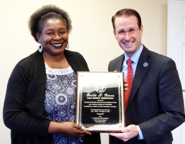 Child Support Administrator retires Bertha Graves receives a plaque from Mike Dunavant