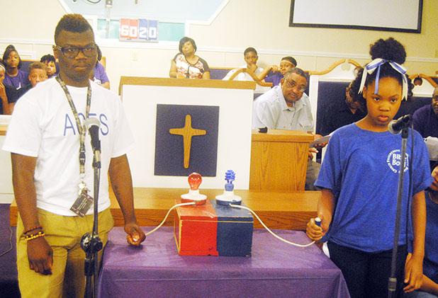 Union Hill M.B. Church hosts fourth annual Bible Bowl Antoine Genes of Greater Springfield and DeVyn Carney of Progressive prepare to buzz in during the finals.