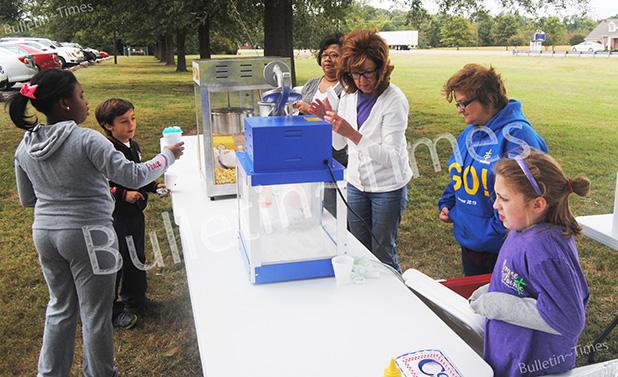 Members and friends of Grace Pointe Church in Whiteville serve up free hotdogs, pop corn and snow cones during a block party held at Whiteville Elementary School