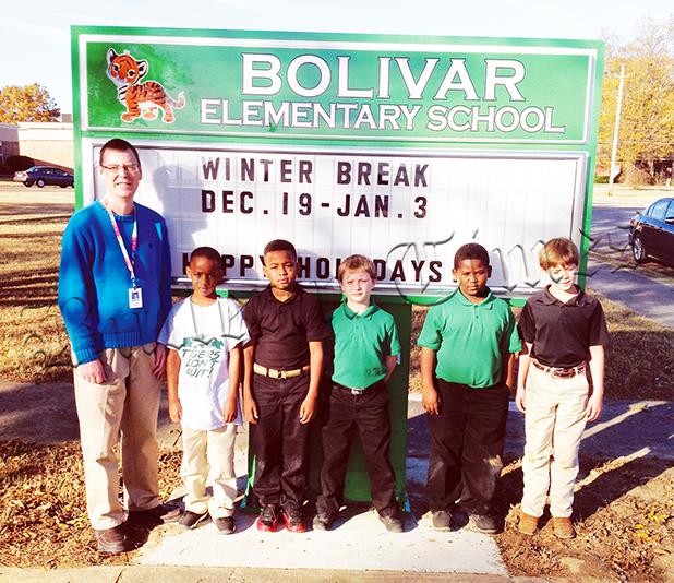New Signs for County School Campuses Bolivar Elementary and Bolivar Middle School received new signs for their campuses from the Hardeman County Schools. At Bolivar Elementary, school principal James Rutherford poses with students.