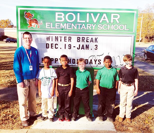 Bolivar Elementary and Bolivar Middle School received new signs for their campuses from the Hardeman County Schools. At Bolivar Elementary, school principal James Rutherford poses with students. 