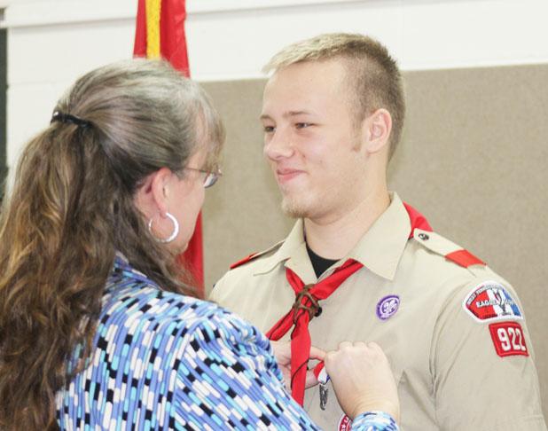 Seven scouts receive Boy Scouts top award Jenny Vincent pins her son, Joshua Vincent, with the Boy Scout Eagle Award during Saturday’s ceremony.