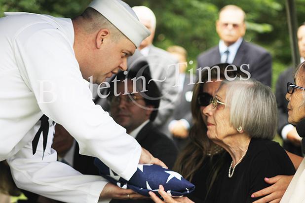Loved ones bid farewell to Navy commander Puckett’s widow, Margaret, is presented with the folded flag from the U.S. Navy in honor of his service to the country.