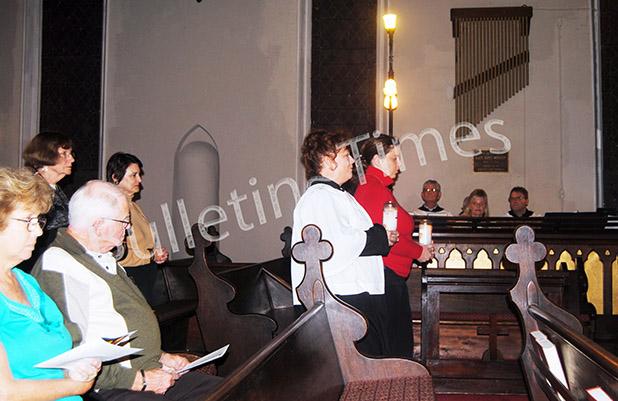 Advent Processional Service begins pre Christmas season Ginger Tester of St. James and Amelia Monroe Carlson of St. Mary’s present the candles of their respective Churches in the start of this year’s Advent Processional Service.