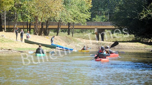 A group of canoers and kayakers approach Charles T. Russell Landing and Hatchie Town River Park.