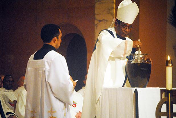 Oils consecrated at Chrism Mass Bishop Terry Steib of the Memphis Diocese of the Catholic Church, mixes the Chrism Oil during the annual Chrism Mass on March 31. The oil will be used by priests within the diocese during confirmation of those entering the Church.