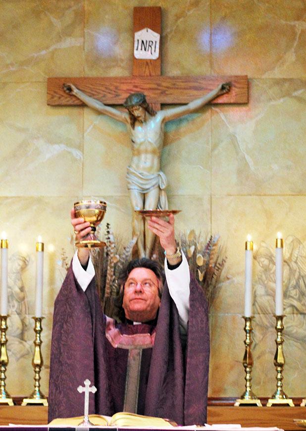 The faces of Christianity: Part 1 Rev. Fr. W.H. Arnold of St. Mary Catholic Church in Bolivar, pictured during Sunday Mass.