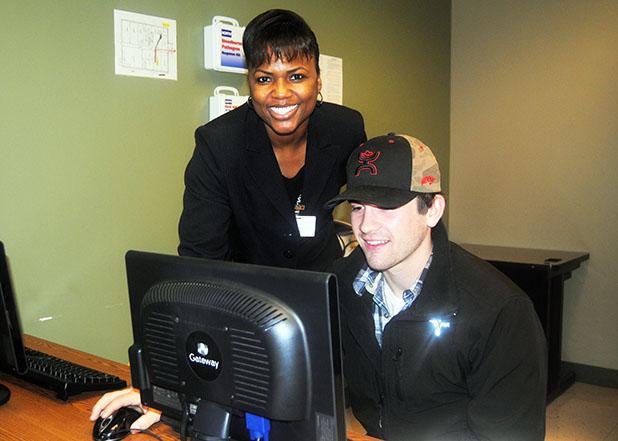 JacQuene Winfield, Student Services Coordinator for TCAT Whiteville, helps Rodney Wilmoth of Somerville sign up for a Tennessee Reconnect grant. 