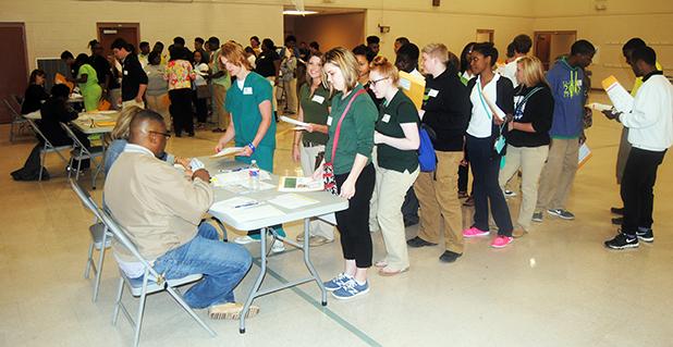 Students line up at the Bursar's office to pay for college fees during the Anycollege simulation. 