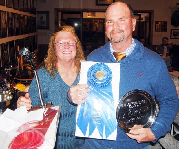 Beverly Matthews, Field Vice President of ESSFTA presents the first place trophy in the puppy division to Mark Hairfield, trainer for Wind River Pippa, owned by Tom and Jeanne Nabity of Grand Island, NE.