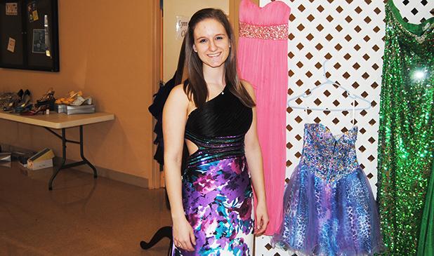 Pictured, Amber Bailey tries on one of the dresses on sale at the “A Second Dance” prom dress sale.