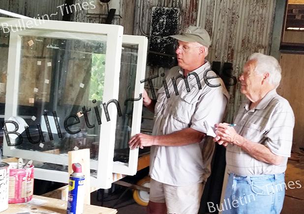 Gerald Wade, president of the Grand Junction Depot Museum Corp. (l), shows Bill Stone, with the Bolivar Bulletin-Times, some of the windows restored as part of Phase One of the Depot preservation.     