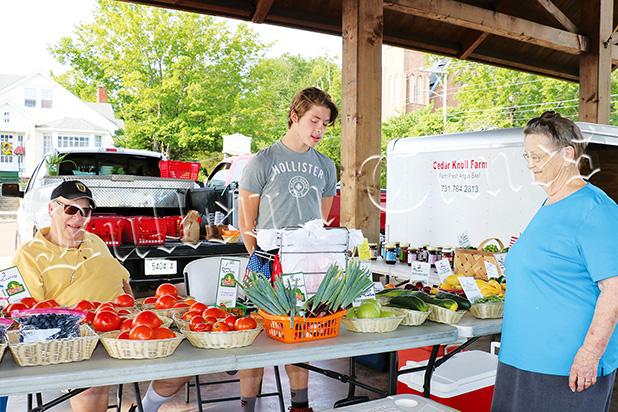 A Farmers Market Family Bill Deen, grandson Houston Bateman and baker/shopper Helen Bourret at the Bolivar Farmers Market on Saturday, June 24.
