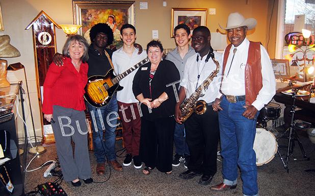 On the Square Gallery and Gifts holds open house Pictured l-r: Kandy Shackelford, (Chamber of Commerce director), Gerald Thornton (guitar) Alan Maguire (bass), Deborah Turner Brasfield (owner of On the Square Gallery and Gifts), Carl Maguire (drums), Reginald White (saxophone), and Mack Carter, Hornsby mayor and president of Chamber of Commerce).