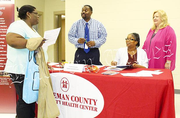 Job Fair Comes to Bolivar Robert Davis, Jr., Cassandra Bufford, and CEO Mary Heinzen from the Hardeman County Community Health Center talk with a patron. Photo by Ginger Tester.