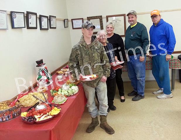 Guests pictured (l-r): Cade Goodwin, Lila Davison, Pat Plunk, Curtis Vandiver, and Terry Parchman prepare to sample some of the hors-d’oeuvres served at the City of Hornsby’s open house on Dec. 19. Pat Plunk and Patricia Parchman put together the assortment of fruits, veggies, cheeses, dips, and sweets. 
