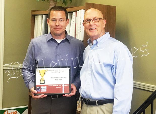 In celebrating National Small Business Week (April 29-May 5, 2018) Joel Newman (right) of the Tennessee Small Business Development Center gave an award to Greg Byers of Unity Health and Wellness Clinic in Bolivar for Outstanding Health Services.