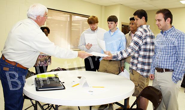 High school seniors talk with Curtis Lane of Wilson Well, Company. High school students were encouraged to attend the fair. Photo by Ginger Tester.  