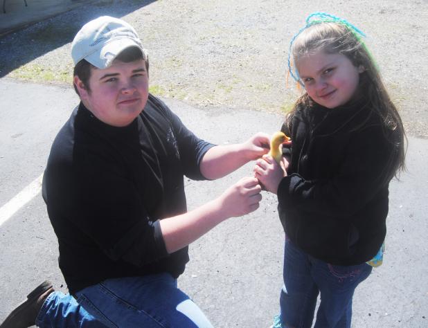 Dixie Hills Baptist Church holds Eggstravaganza Truman Mayfield allows Bethany Hopper to hold a baby duckling at the petting zoo.