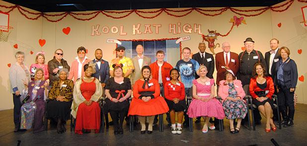 HCAC presents “Murder at Kool Kat High” The cast of “Murder at Kool Kat High” Seated (l-r): Cecilia (CC) Hadley (Rah Rah La Roux), Gladis Thomas (Ruby Tuesday), Demetria McTizic (Lollipop), Ginger Hillman Crowe (Antoinette FUNachello), Ashley Trainum (Veronica Von Pond), Johnbernae Hudson (Trixie Dixie), Autumn Trainum (Babsi Doll), Denise Estes (Miss Connie Brooks), Mica Shelly Harris (Bambi La Bomba). Standing (l-r): Wanda Young (Director), Stacie Grantham (Flash O’Hara), Tim Moss (Jamie Dean), Gary Byers (Elvis Pretzel), Illya Higgs, (Greased