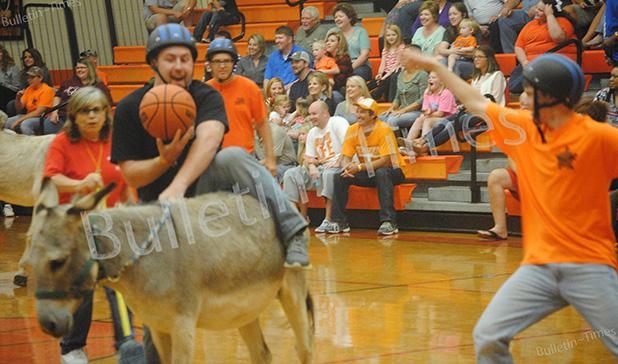 Matthew Maness tries to get on his donkey with the ball