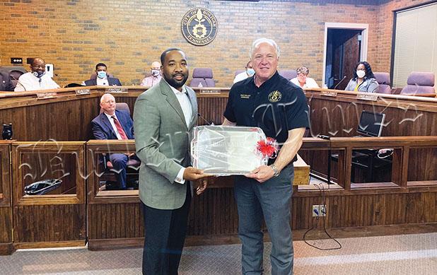 Bolivar Mayor Julian McTizic presents Walley with a silver platter to commemorate his time as a city councilman.