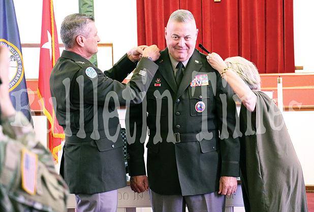 Tennessee Adjutant General Major General Jeff Holmes and wife Becky Ross pin the hardware on Ross during the ceremony.