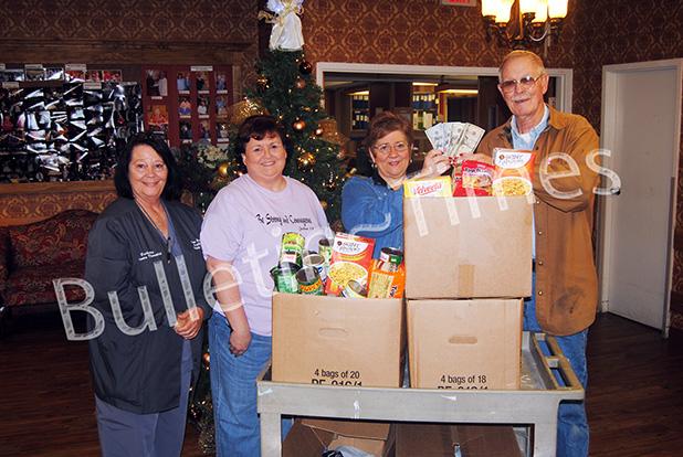 Staff members at Pine Meadows Healthcare present $250 and more than 150 cans of food to Loaves and Fishes. Pictured (l-r): Barbara Gammel activities director, Reba Weaver PBC/AP, Glenda McCartney administrator, Bo Lain administrator of Loaves and Fishes.