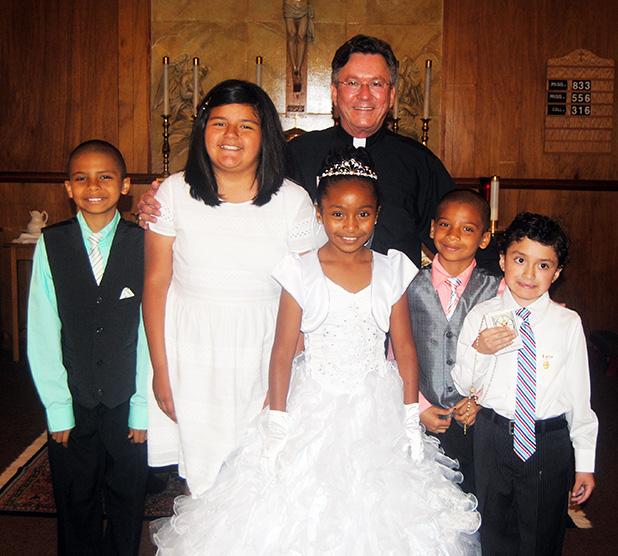 St. Mary’s holds First Communion Members receiving Communion: Cynthia Macias, Raquel Harry, Demetrius Edgeston, Jaylen Edgeston, Diego Chavira, with Rev. Fr. W.H. Arnold in back.