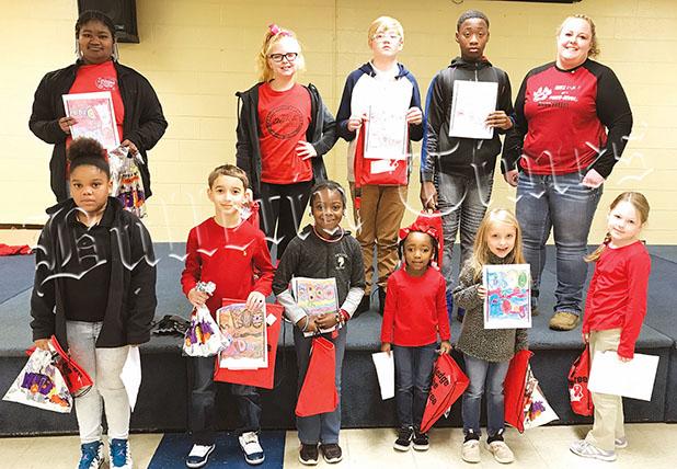 WES Celebrates Red Ribbon Days Coloring Contest Winners left to right back row: Taniya Starks, Maci Slavens, Josef Slavens, Awarion Barnett, Officer Howell. Front row: Taziayha Simon, Austin Malena, Carlee Clayborne, Madison Thomas, Kassi Duncan