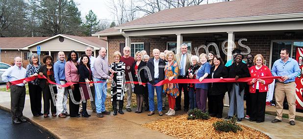 Sylvia Alexander, property manager for Ridgecrest Apartments in Bolivar cuts the ribbon officially dedicating the newly refurbished apartment complex during an open house on Dec. 16.
