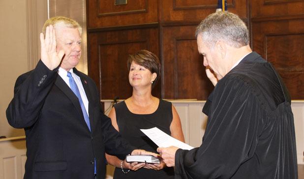 ‘It’s time to get to work’ Jimmy Sain, with his wife Kim holding the Bible by his side, is sworn in as mayor of Hardeman County by Judge Charles ‘Chip’ Cary.