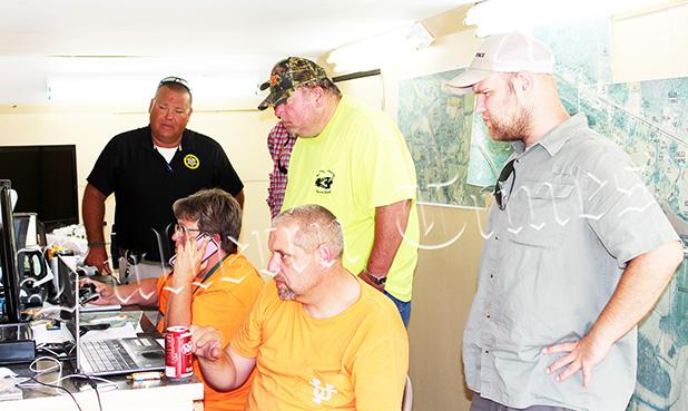 Search for Missing Man Continues Sheriff Doolen and members of the search team watch live drone footage scanning the area. Photo by Jessica Simmons