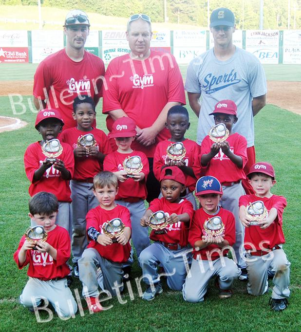 Members of The Gym and their caches proudly display their first place trophies after defeating David Dorris Logging 12-9 in the championship game of the Dizzy Dean 5-6 years old Division on Tuesday, June 9.