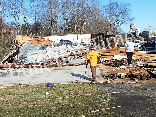 In the tornado’s aftermath Hardeman County Sheriff John Doolen surveys the damage brought about by the tornado that touched down along Highway 125 near the Tennessee/Mississippi line. The demolished building behind Doolen was a convenience store which had been closed. Photo by Bill Stone