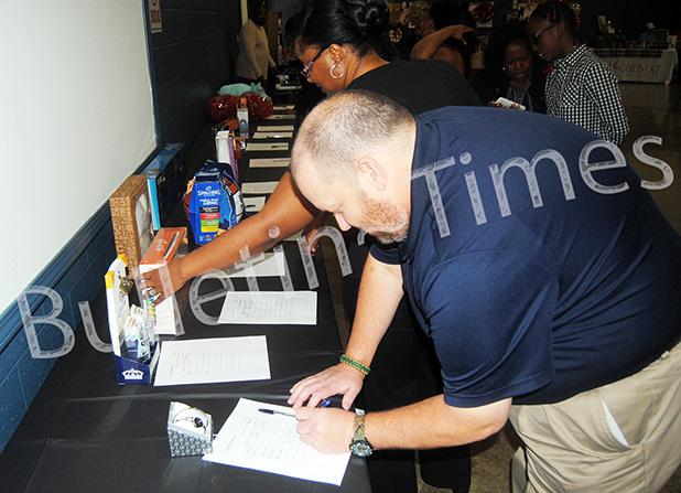 Mike Kennamore makes a bid in the silent auction at the Mid South Toys for Tots fundraiser.