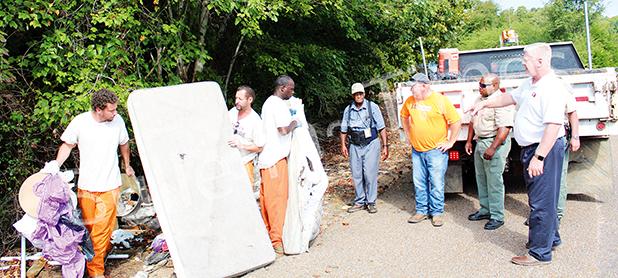 Trustees from the Sheriff’s Department, Sheriff’s Deputies, Hardeman County Solid Waste Director Kenny Brown and Mayor Sain pitch in to clean up an illegal dumping site on Hannis Road on September 9. 