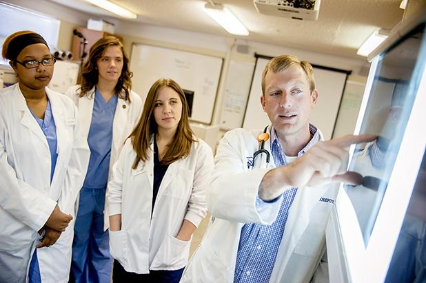 Record number of UT Martin students attend vet school in the fall Dr. Jason Roberts (right), associate professor of animal science at the University of Tennessee at Martin, explains an x-ray to a group of students. Eighteen UT Martin students have been accepted into veterinary school programs beginning this fall, breaking the previous record of 10 students, set in 2013.