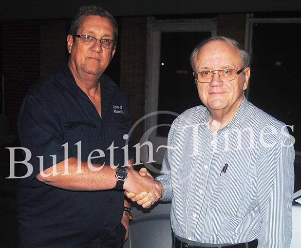 Louis Coleman,director of Whiteville Water and Wastewater is congratulated by Whiteville Mayor James Bellar after the city won a regional contest for the best tasting water in West Tennessee.