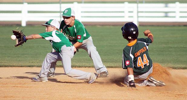 Eli Yopp catches a throw to second, with Peyton Brown behind, as a Vikings runner steaks second. 
