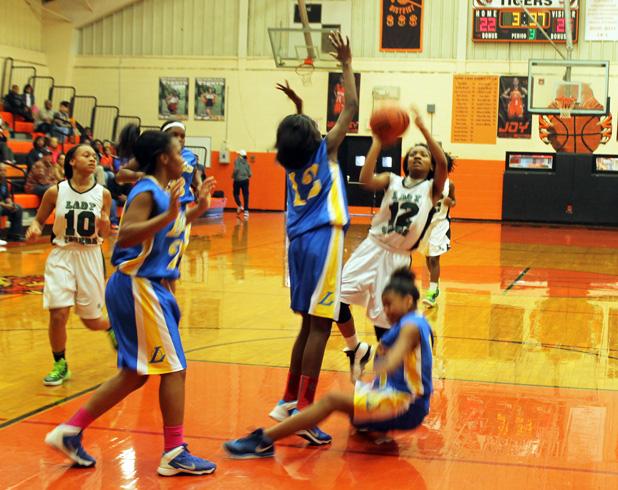 Whiteville Lions Bow Out in Tournament Opener In a physical matchup between Bolivar and Whiteville girls during the county tournament, Hailey Hardaway goes up for a shot over Whiteville’s Jamecia Sangster.