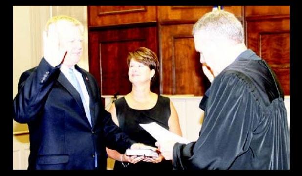 Amelia Monroe Carlson Jimmy Sain, with his wife Kim holding the Bible by his side, is sworn in as mayor of Hardeman County by Judge Charles ‘Chip’ Cary.