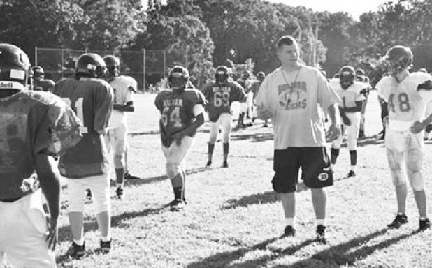 Jennifer Smeltser BMS Head Football Coach Brian Mays discusses strategy with his players.
