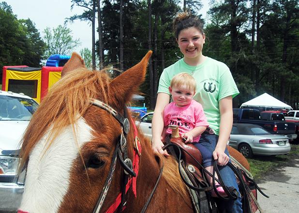 Even the young can enjoy the ride. Kaitlyn Howell takes one year old Cheyenne Phelps for a quick ride.