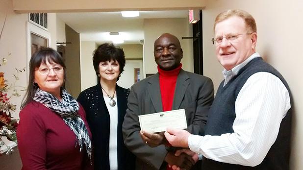 In their continued commitment to the community, President Tommy Sain (right) presents Merchants & Planters Bank’s annual contribution to members of the HCIL Board of Directors, Jackie Hickey, Cathy Mayfield and Monroe Woods. 